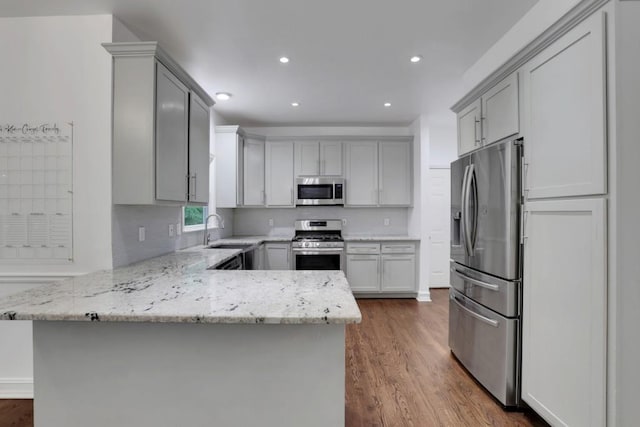 11280 Brookhollow Trl, Alpharetta, GA 30022 - kitchen with stainless steel appliances, gray cabinetry, a peninsula, a sink, and recessed lighting
