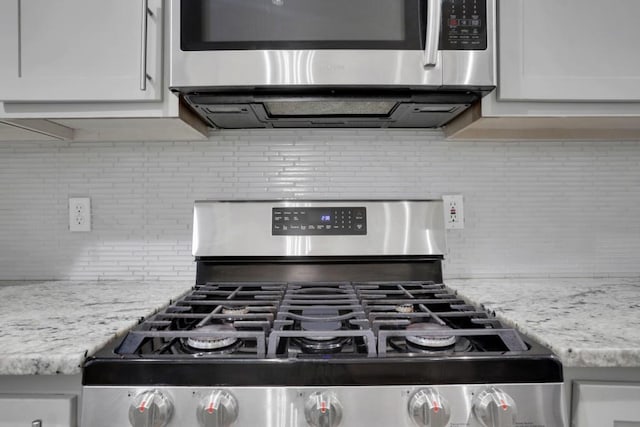 11280 Brookhollow Trl, Alpharetta, GA 30022 - kitchen view of stainless steel appliances, decorative backsplash, white cabinets, and light stone counters