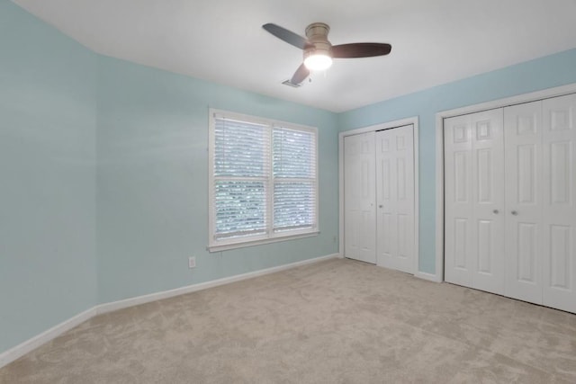 11280 Brookhollow Trl, Alpharetta, GA 30022 - unfurnished bedroom with multiple closets, carpet flooring, baseboards, and ceiling fan