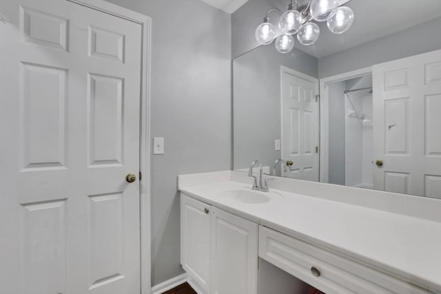 11280 Brookhollow Trl, Alpharetta, GA 30022 - bathroom featuring vanity, baseboards, and a chandelier