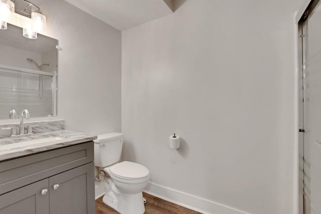 11280 Brookhollow Trl, Alpharetta, GA 30022 - bathroom with baseboards, a shower with shower door, vanity, toilet, and wood finished floors