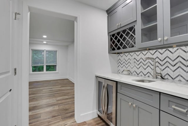 11280 Brookhollow Trl, Alpharetta, GA 30022 - indoor wet bar with baseboards, decorative backsplash, light wood finished floors, recessed lighting, and beverage cooler