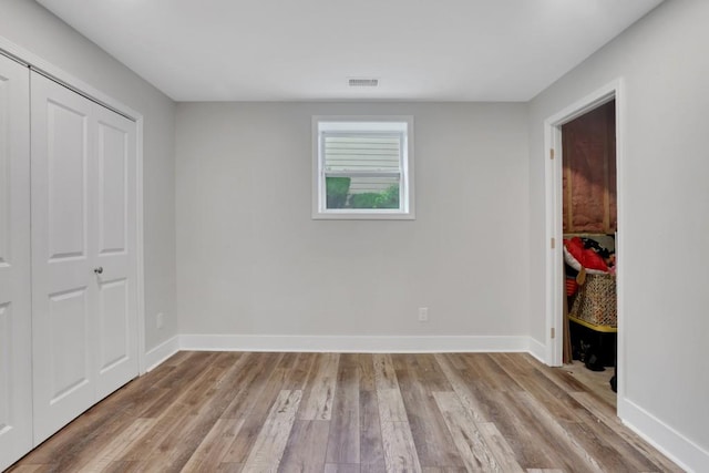 11280 Brookhollow Trl, Alpharetta, GA 30022 - unfurnished bedroom with light wood-style flooring, baseboards, and a closet