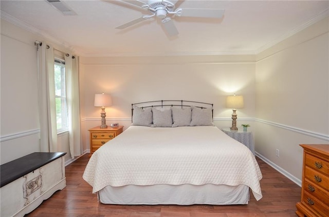 bedroom featuring visible vents, ornamental molding, ceiling fan, and wood finished floors