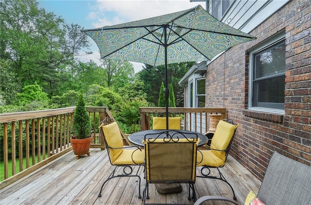 wooden terrace with outdoor dining area