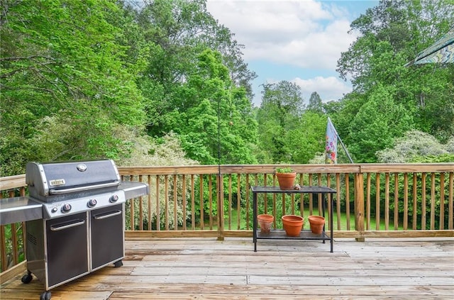 wooden terrace with a grill