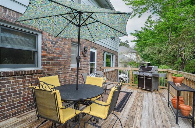wooden deck featuring outdoor dining area and grilling area