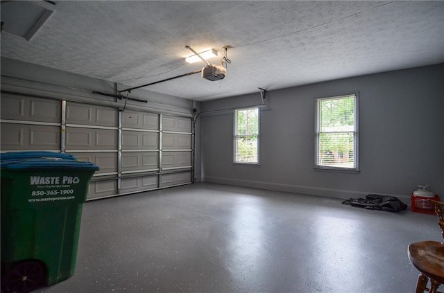 garage with baseboards and a garage door opener