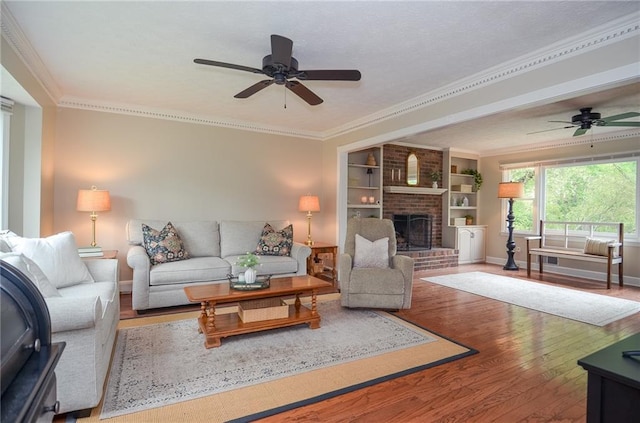 living room featuring a ceiling fan, baseboards, and wood finished floors