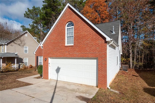 view of property exterior with central AC and a garage