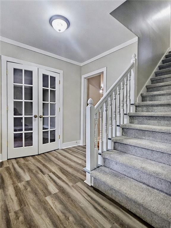 interior space with french doors, hardwood / wood-style floors, and ornamental molding