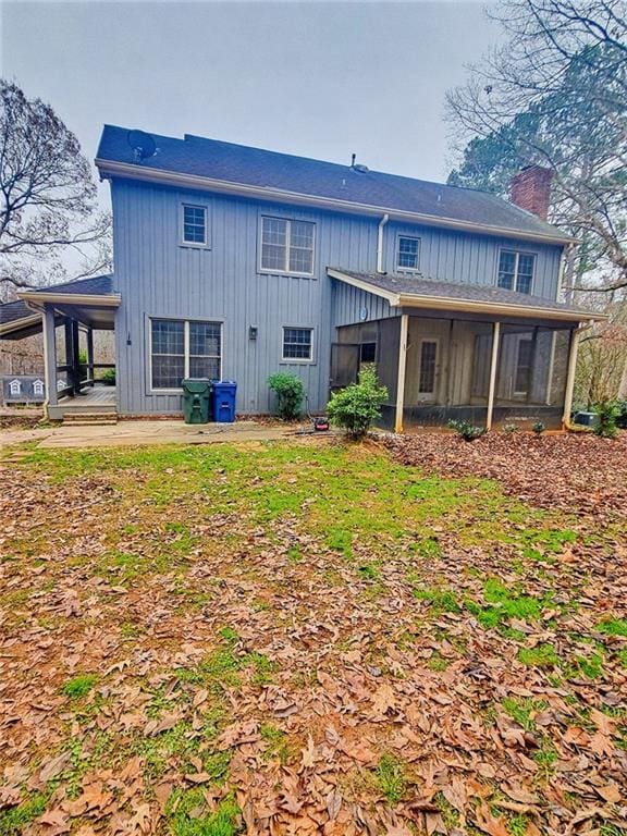 rear view of house featuring a patio and a sunroom