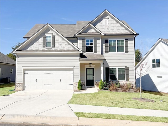 418 Brookstone Trl, Dawsonville, GA 30534 - craftsman-style house with driveway, a front yard, a garage, and brick siding