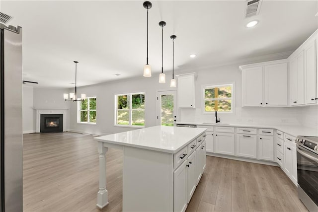 418 Brookstone Trl, Dawsonville, GA 30534 - kitchen featuring appliances with stainless steel finishes, light wood finished floors, recessed lighting, light countertops, and white cabinets
