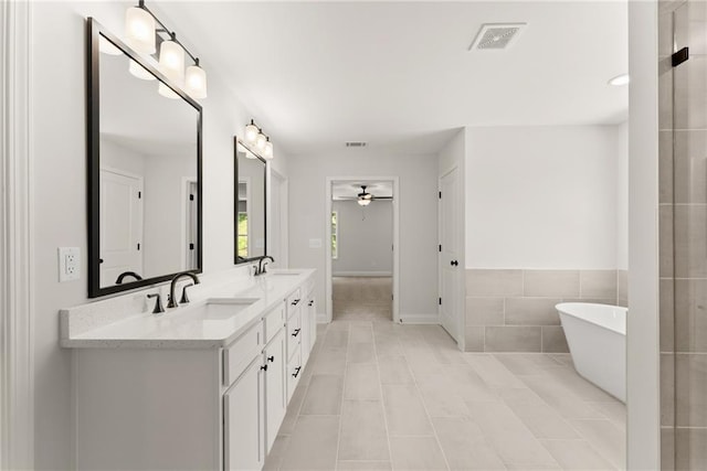 418 Brookstone Trl, Dawsonville, GA 30534 - bathroom featuring ceiling fan, a freestanding bath, double vanity, and tile patterned floors