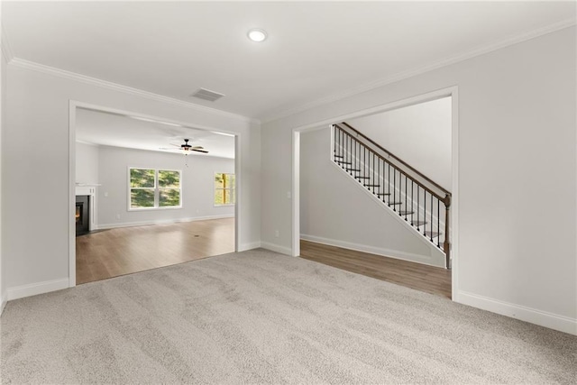 418 Brookstone Trl, Dawsonville, GA 30534 - unfurnished living room featuring carpet floors, crown molding, stairway, baseboards, and ceiling fan