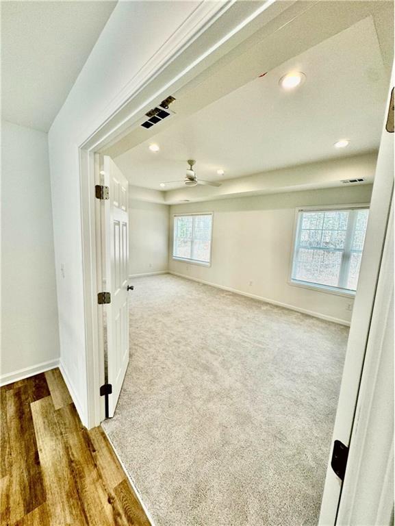 carpeted empty room with ceiling fan