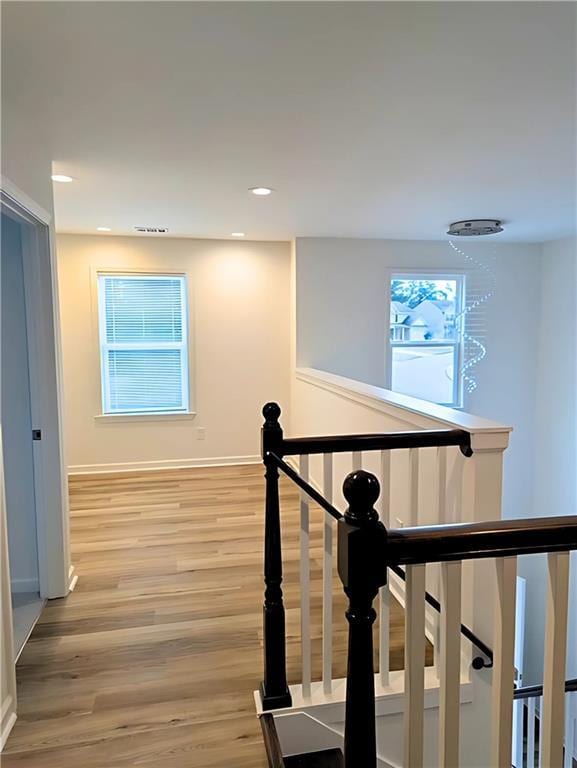 corridor with hardwood / wood-style flooring