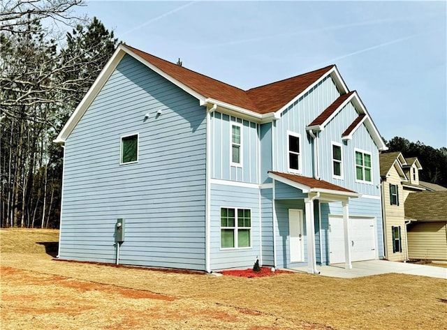 view of front of house with a garage and a front lawn