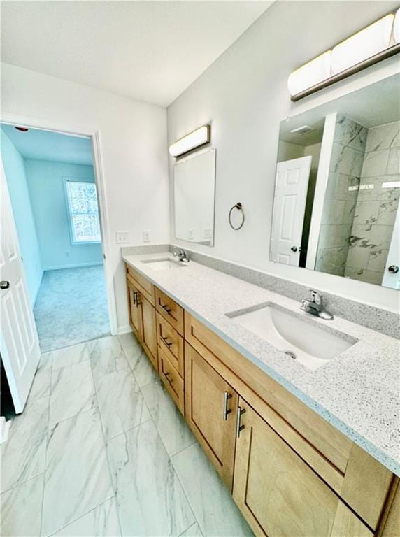 bathroom with vanity and tiled shower