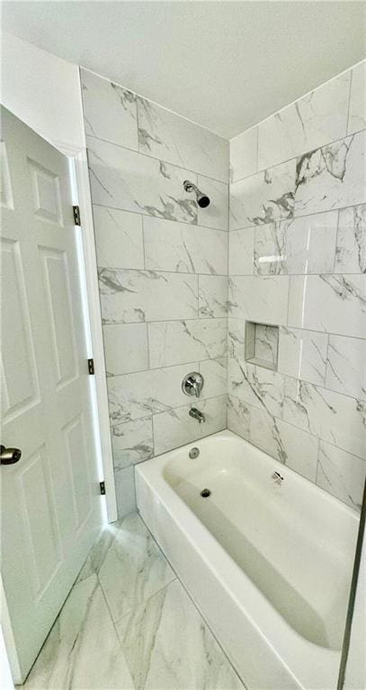 bathroom featuring tiled shower / bath