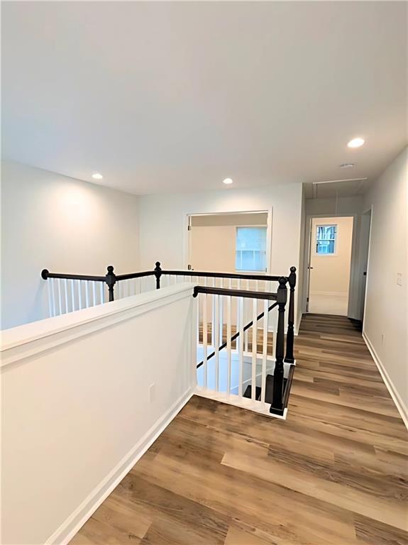 corridor with hardwood / wood-style floors