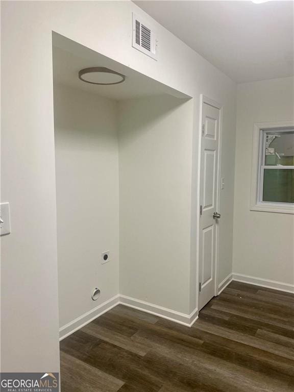 laundry area featuring dark wood-style floors, electric dryer hookup, and baseboards