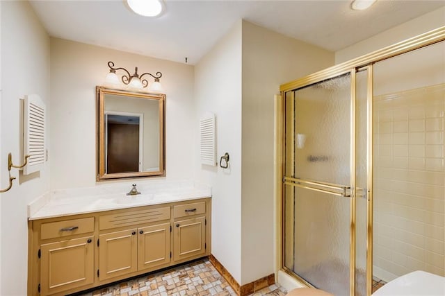 full bath featuring a shower stall, vanity, and baseboards