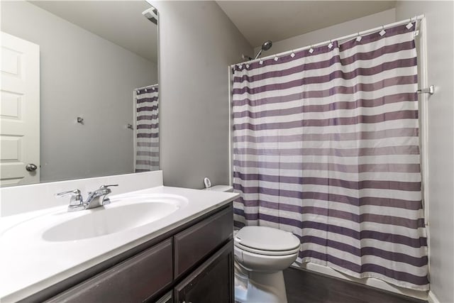 bathroom with hardwood / wood-style floors, toilet, and vanity