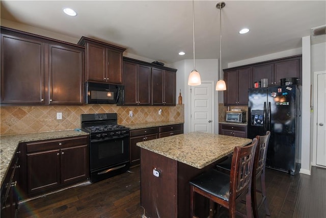 kitchen with black appliances, pendant lighting, dark hardwood / wood-style floors, and tasteful backsplash