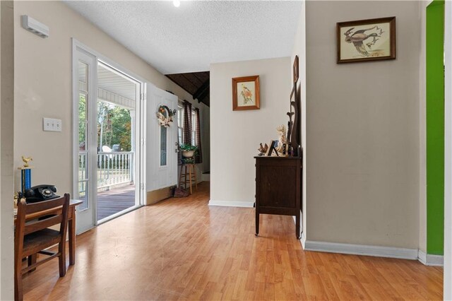 foyer with light hardwood / wood-style floors and a textured ceiling