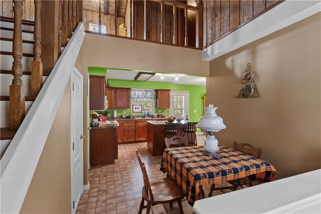 dining room featuring a towering ceiling