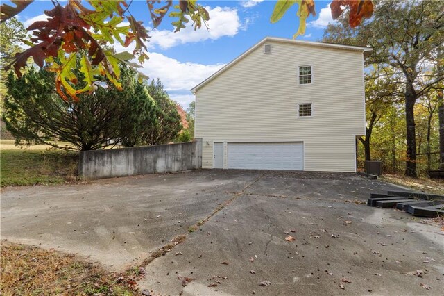 view of side of home featuring a garage