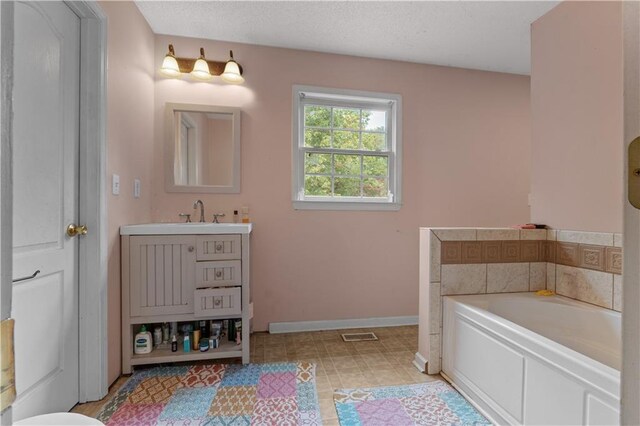 bathroom with vanity and a washtub