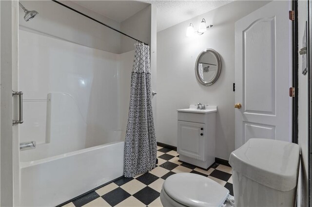 full bathroom with vanity, shower / tub combo with curtain, and toilet