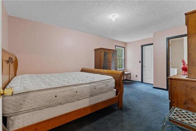 carpeted bedroom featuring a textured ceiling