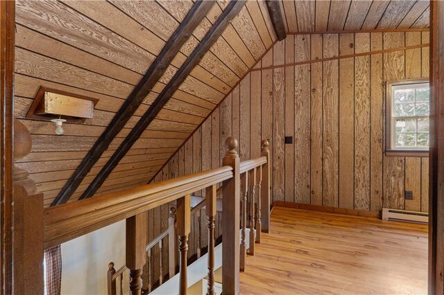 bonus room with a baseboard radiator, vaulted ceiling, light wood-type flooring, and wooden ceiling