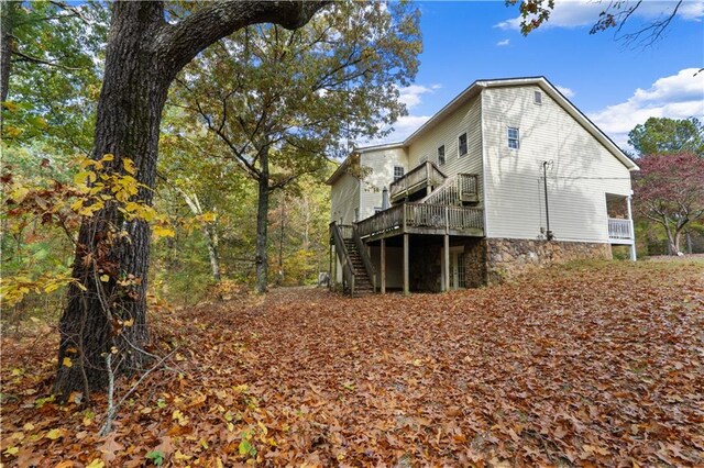 view of side of property featuring a wooden deck