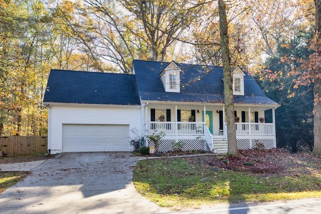 new england style home featuring covered porch and a garage