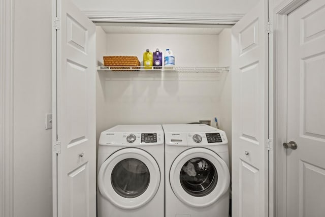 laundry room with washing machine and clothes dryer