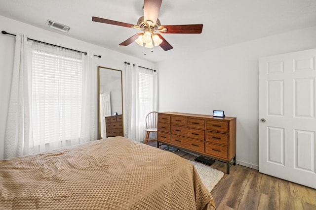 bedroom with hardwood / wood-style floors and ceiling fan