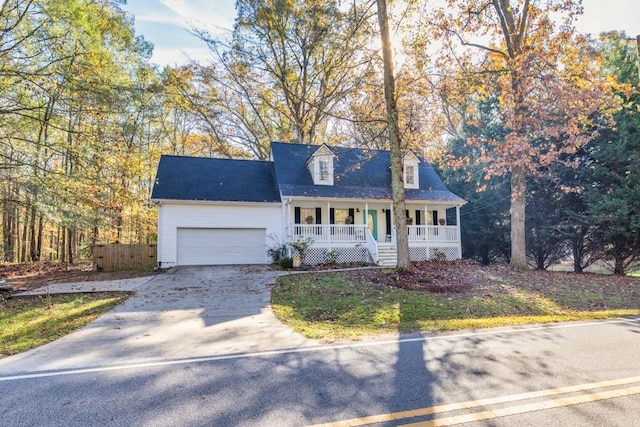 cape cod-style house featuring a porch and a garage