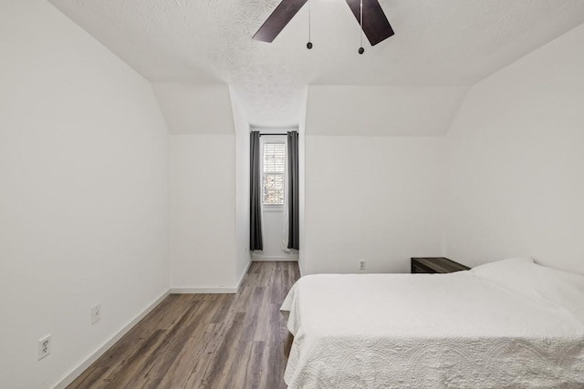 bedroom featuring a textured ceiling, ceiling fan, wood-type flooring, and lofted ceiling