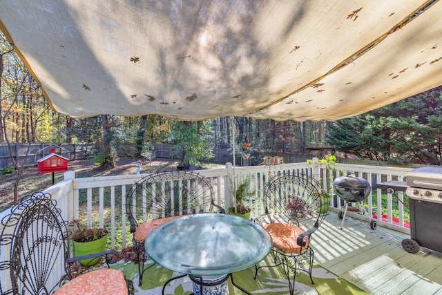 wooden terrace featuring a grill