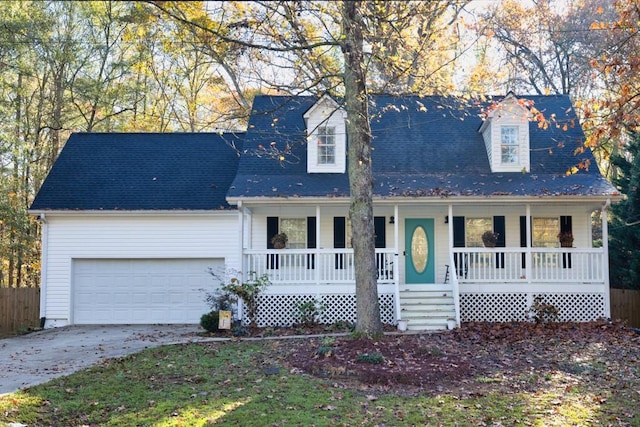 cape cod-style house featuring covered porch and a garage