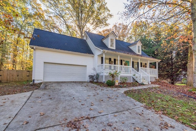 cape cod-style house with covered porch and a garage