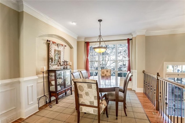 dining space with crown molding