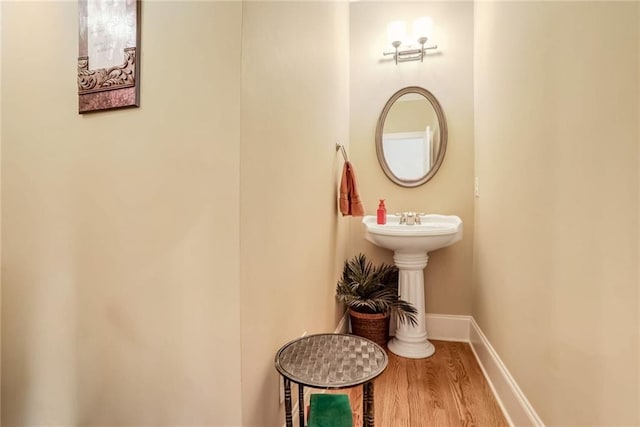 bathroom featuring wood-type flooring and sink