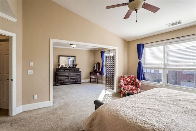 carpeted bedroom with ceiling fan, crown molding, and vaulted ceiling