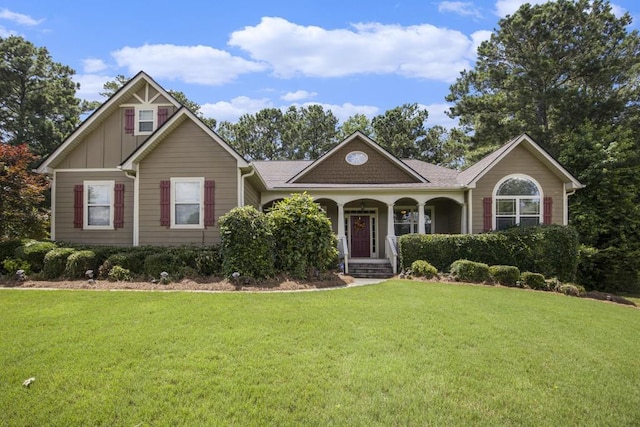 212 Westwind Dr, Newnan, GA 30263 - view of front of house featuring a front yard, covered porch, and board and batten siding